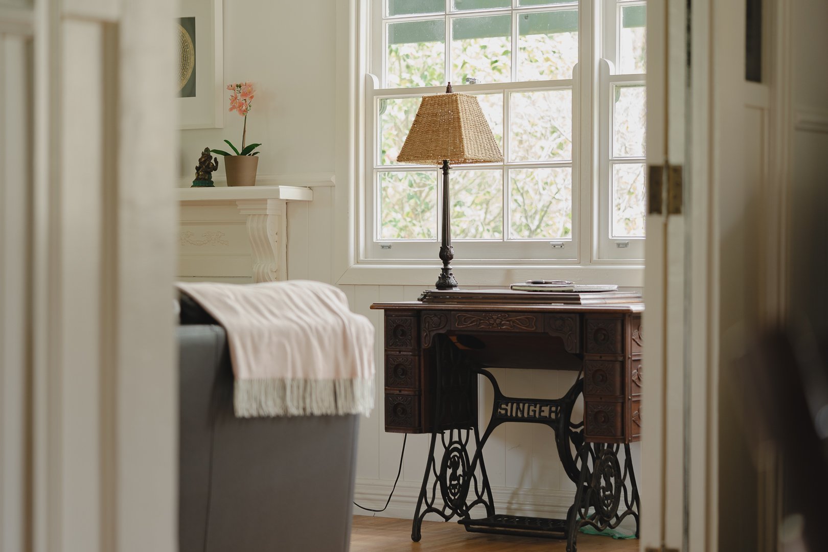 An old Singer sewing table by the window.