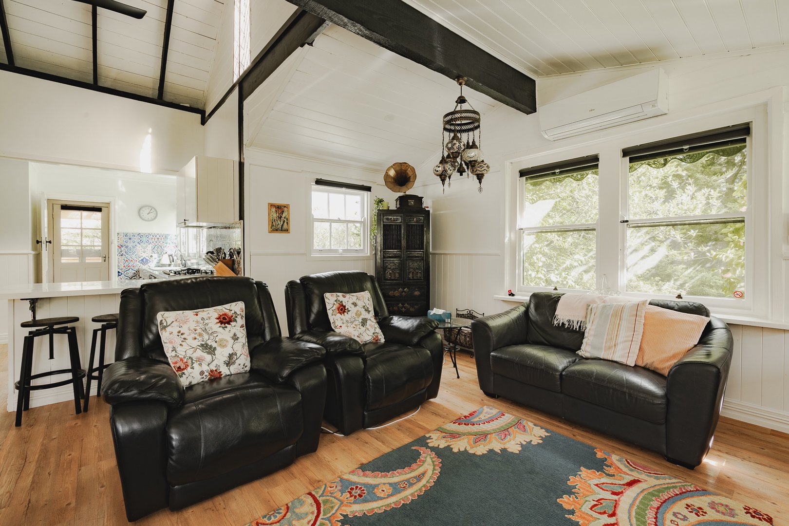 The lounge at White Rose Cottage, vaulted ceiling and open fire.